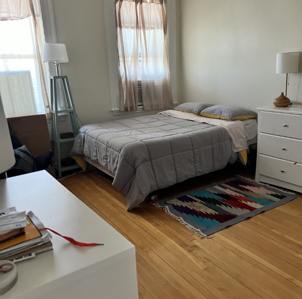 Freshly cleaned Boston bedroom with hardwood floors and natural light